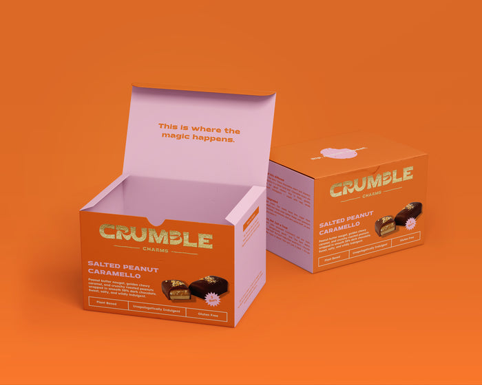 Salted Peanut Caramello chocolate bar box packaging by Crumble Charms on orange background, gluten-free vegan treats